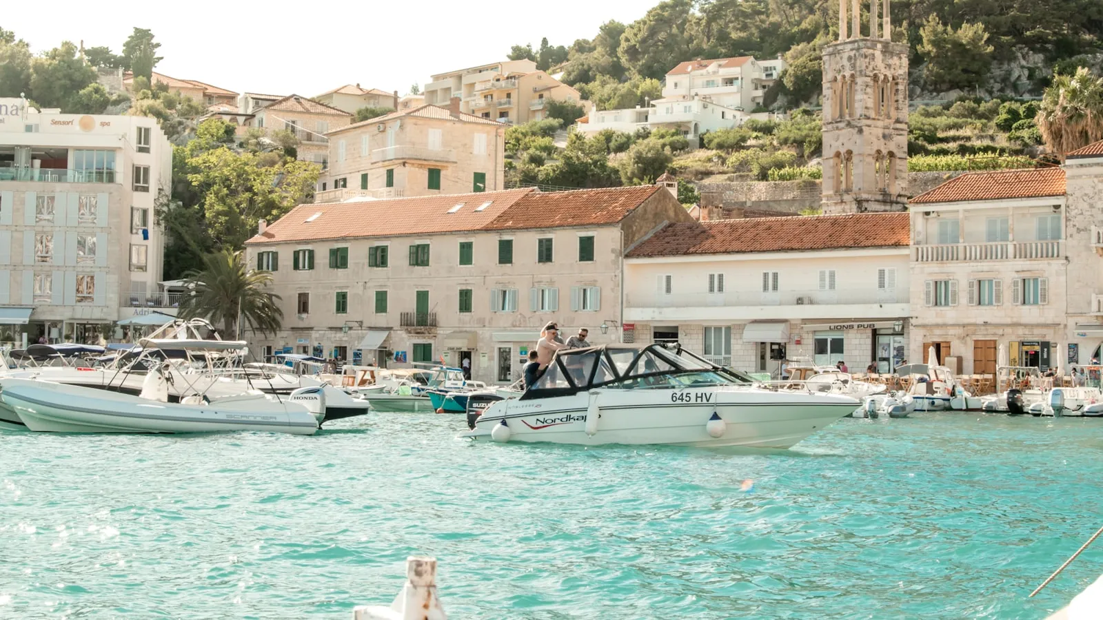white boats near the port at daytime